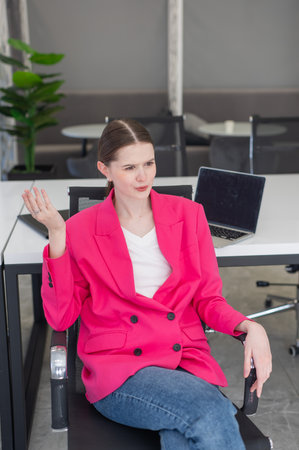 Caucasian woman relaxing while sitting at her deskの写真素材