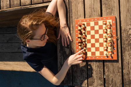 Caucasian woman playing chess outdoorsの写真素材