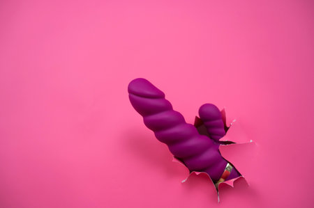 Raspberry object sticks out of pink paper background. Copy spaceの写真素材