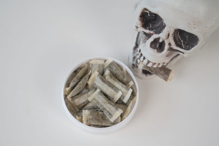 Skull Chewing Tobacco on a White Table