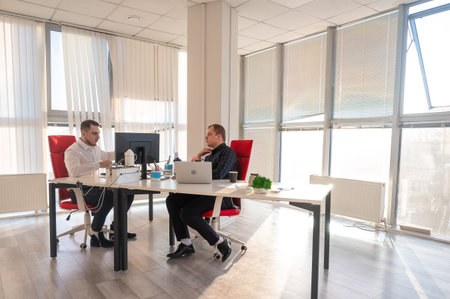 Two Caucasian men working in an office