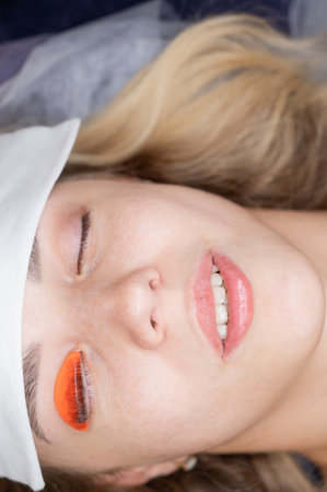 Caucasian woman undergoing eyelash lamination procedureの写真素材