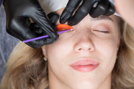 Caucasian woman undergoing eyelash lamination procedure