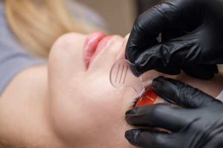 Caucasian woman undergoing eyelash lamination procedureの写真素材