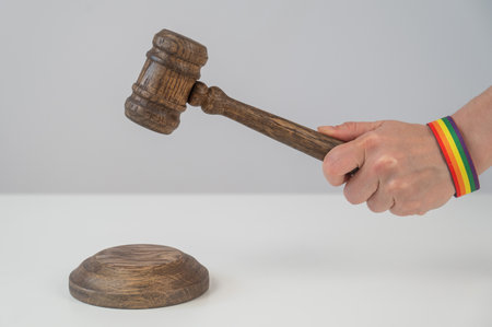 Judge with rainbow bracelet hits gavelの写真素材