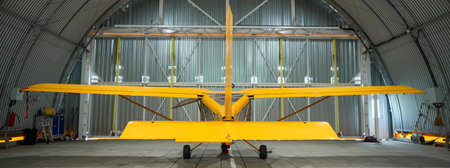 Yellow airplane glider in the hangarの写真素材