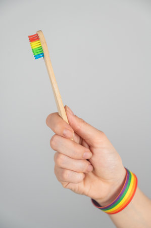 Woman wearing bracelet holds toothbrushの写真素材