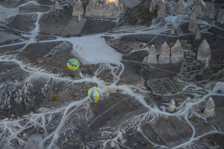 Balloons fly over Cappadocia at sunriseの写真素材