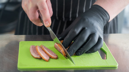 The chef slices the roast duckの写真素材