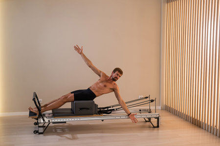 A man doing Pilates on a reformerの写真素材