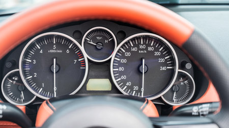Close-Up View of a Sports Car Dashboard Displaying Gaugesの写真素材