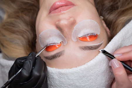 The process of professional lamination and dyeing of eyelashes and eyebrows in the salon. Four-handed procedureの写真素材