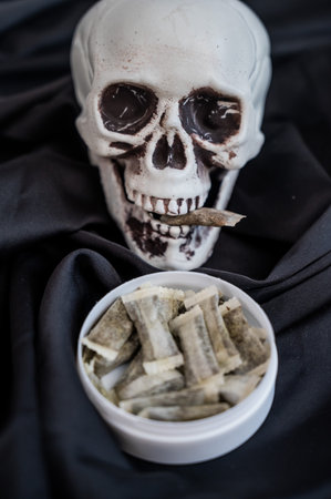 Skull Chewing Tobacco on Black Clothの写真素材