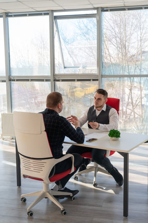 Two Caucasian men communicating at a business meeting