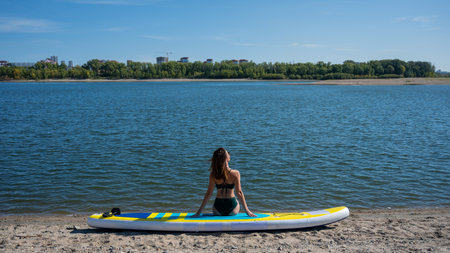 Caucasian woman posing on a SUP board. Summer sportの写真素材