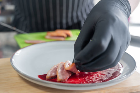 The chef places the duck on cranberry sauceの写真素材