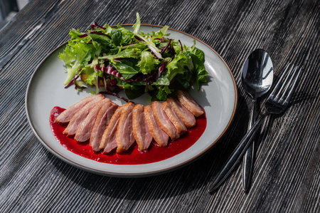 Roasted duck cut into pieces on a plateの写真素材