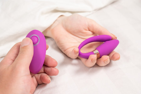 Female hand with curved remote control vibratorの写真素材