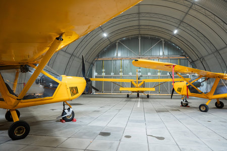 Yellow airplane glider in the hangarの写真素材