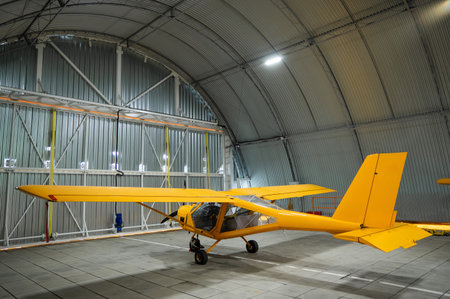 Yellow airplane glider in the hangarの写真素材
