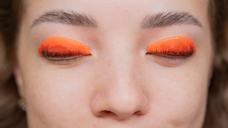 Caucasian woman undergoing eyelash lamination procedure. top viewの写真素材