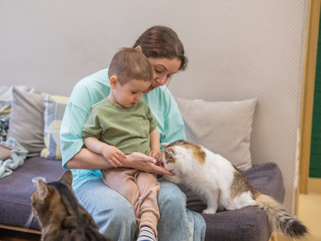Caucasian woman with her son in a cat cafeの写真素材
