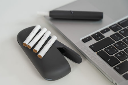 Tobacco heating system next to a laptop