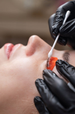 Caucasian woman undergoing eyelash lamination procedureの写真素材