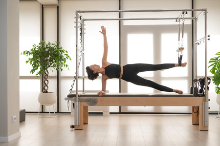 Asian woman doing pilates on reformerの写真素材