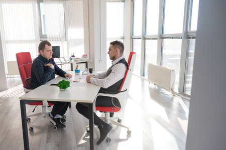 Two Caucasian men communicating at a business meetingの写真素材