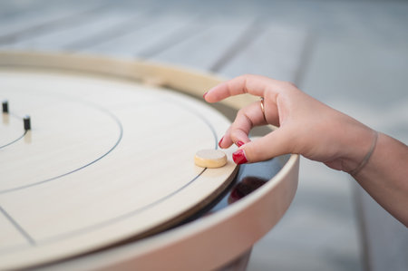 Strategic Game Pieces on a Wooden Board crokinole