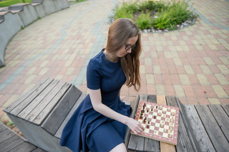 Caucasian woman playing chess outdoorsの写真素材