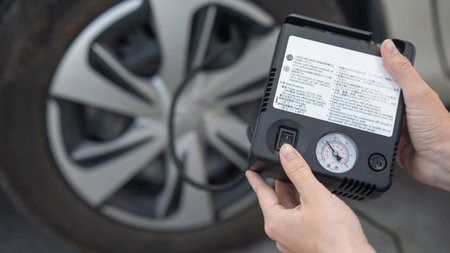 Woman holding a car tire pump
