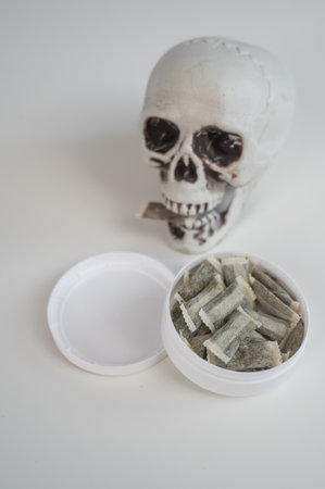 Skull Chewing Tobacco on a White Tableの写真素材