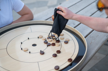Strategic Game Pieces on a Wooden Board crokinoleの写真素材
