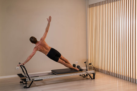 A man doing Pilates on a reformerの写真素材