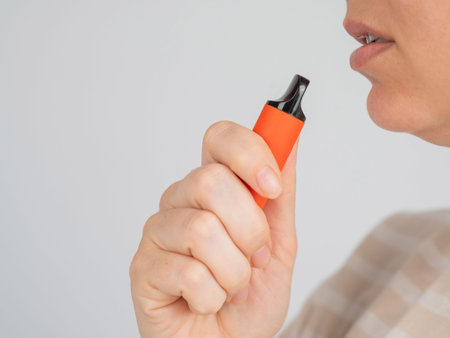 Caucasian woman smoking disposable vape