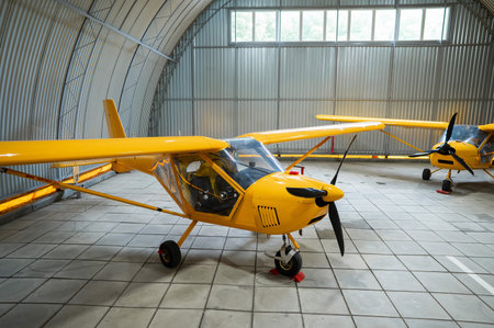 Yellow airplane glider in the hangarの写真素材
