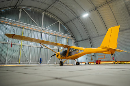 Yellow airplane glider in the hangarの写真素材