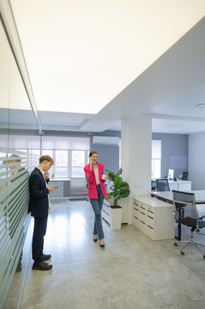 Colleagues use smartphones during breaks at workの写真素材