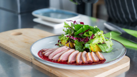 The chef serves roast duckの写真素材