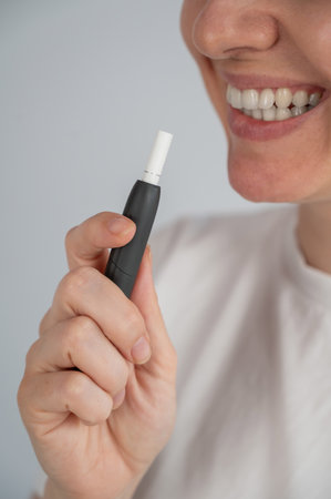 Woman holding a vaping device. Vaping deviceの写真素材