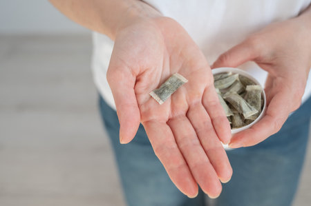 A woman holds a jar of chewing tobaccoの写真素材