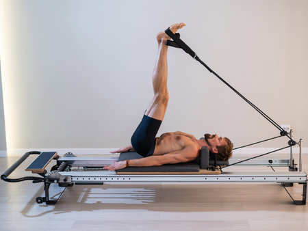 A man doing Pilates on a reformerの写真素材