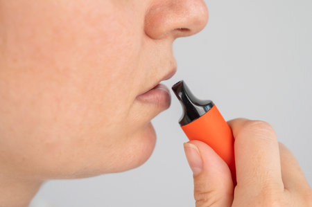 Caucasian woman smoking disposable vapeの写真素材