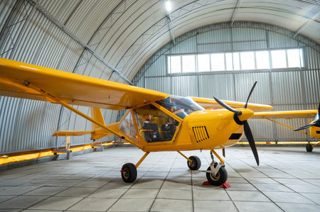 Yellow airplane glider in the hangarの写真素材