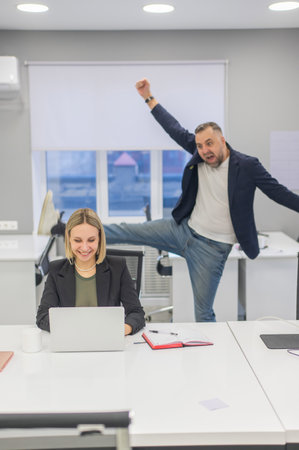 Colleagues fooling around at work in the officeの写真素材