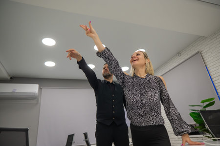 Coworkers are fooling around and launching airplanes in the office