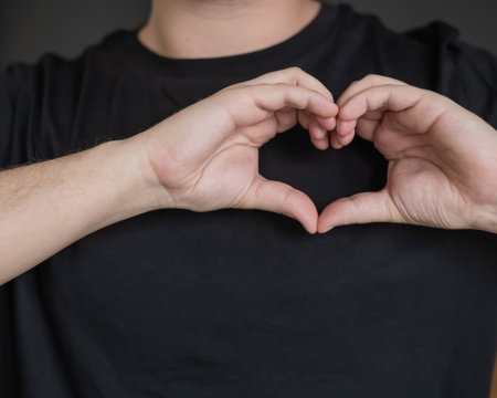 Caucasian man showing heart signの写真素材
