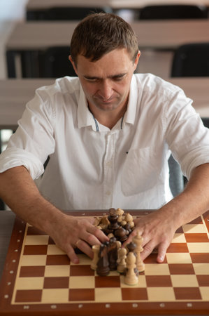 Middle aged Caucasian man playing chessの写真素材